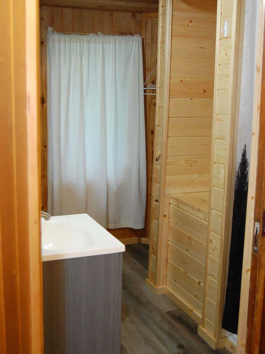 A Bathroom With A White Curtain